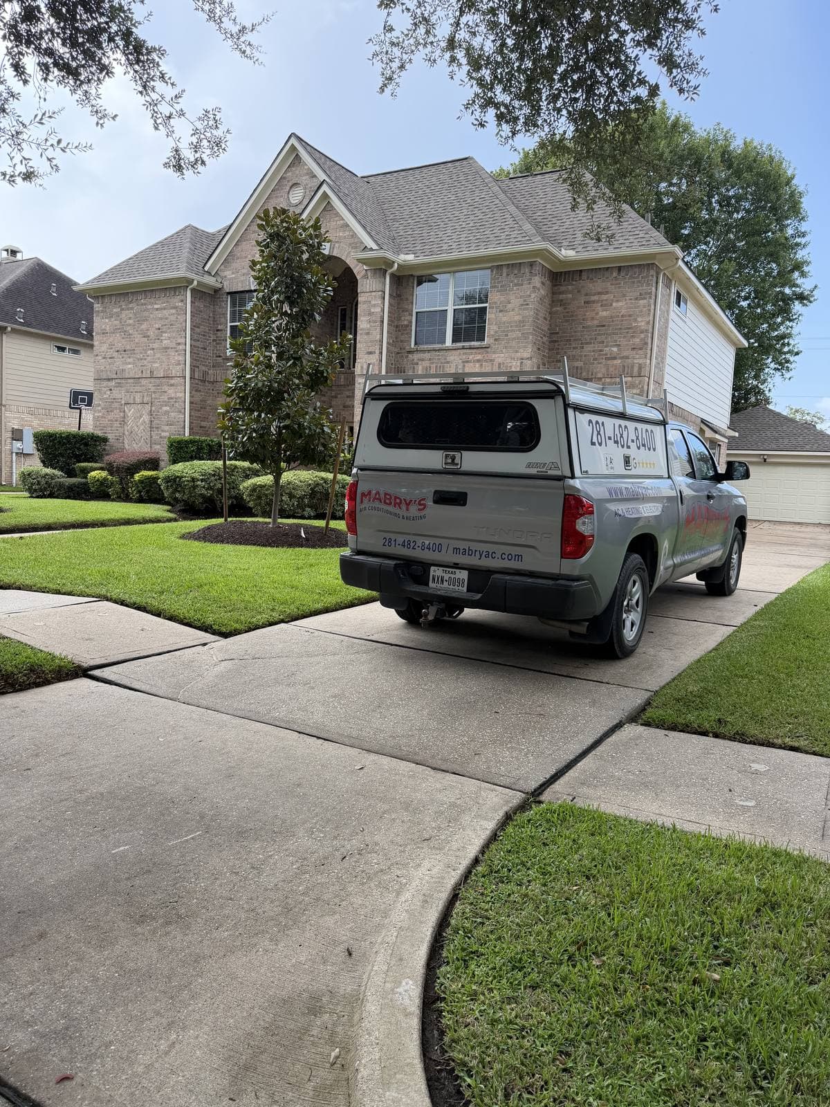 Mabry's Air Conditioning & Heating branded service truck at a League City, TX home
